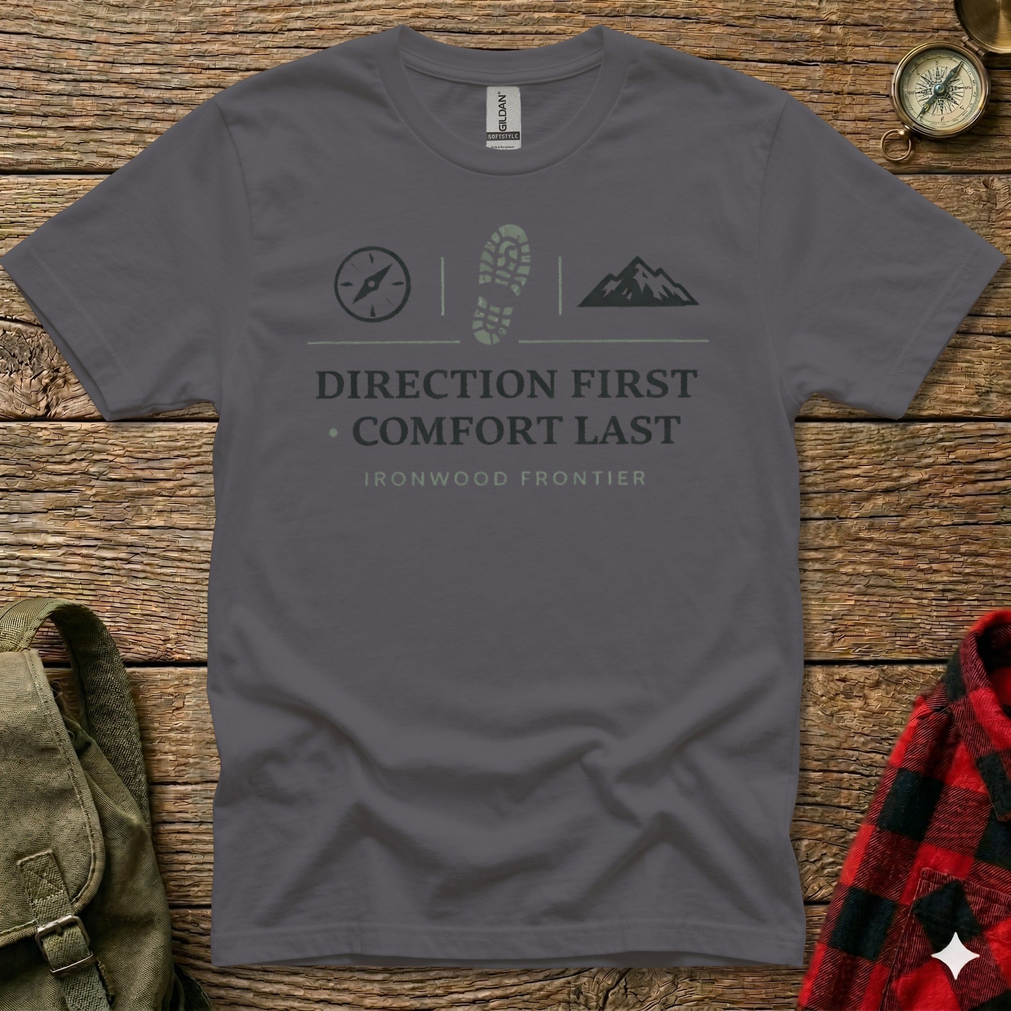 Gray t-shirt with compass, boot, and mountain icons above text.