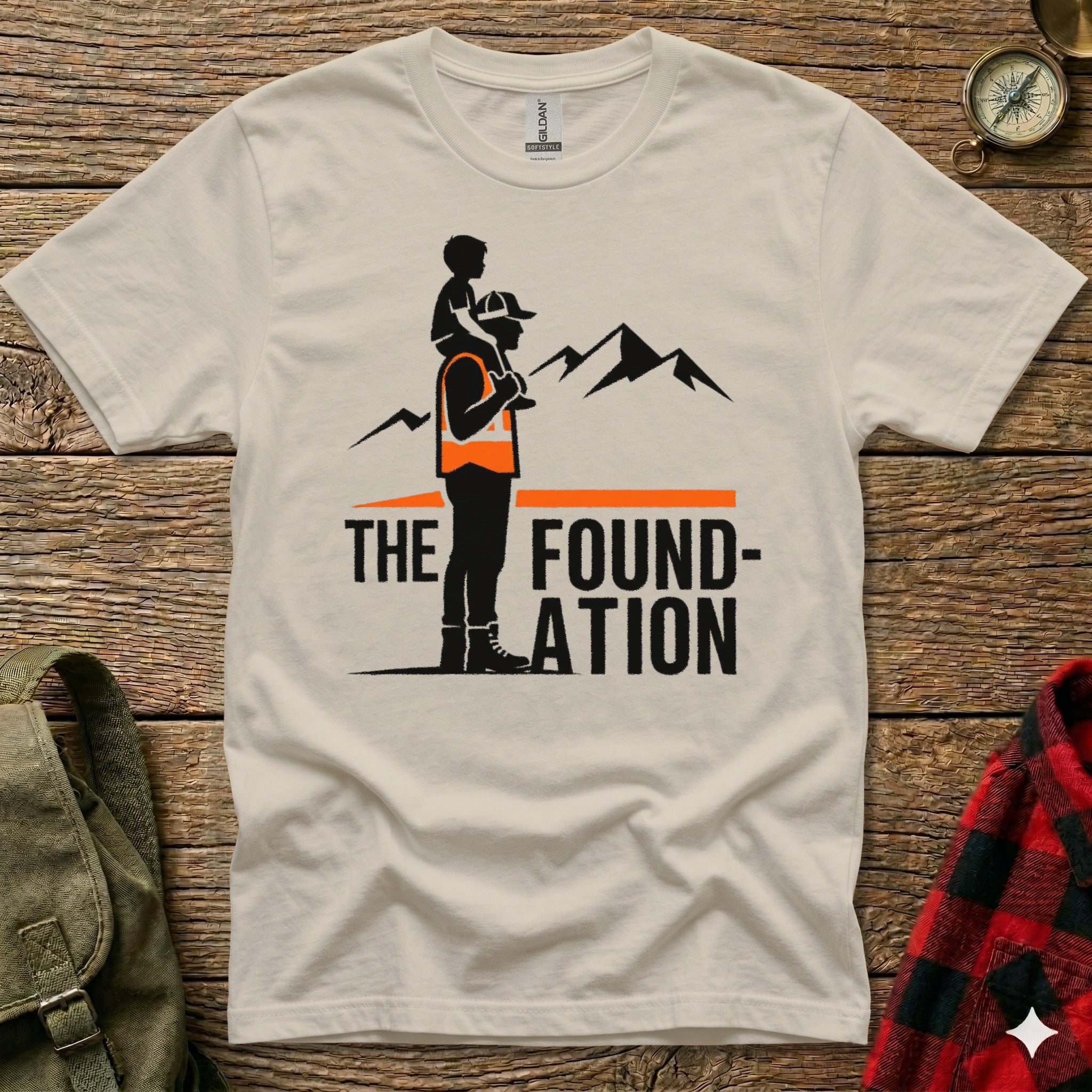 T-shirt graphic with text "The Foundation" and silhouette of father carrying child.