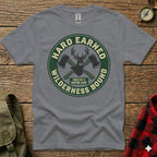 Grey t-shirt with circular "Hard Earned Wilderness Bound" logo featuring crossed axes and antlers.