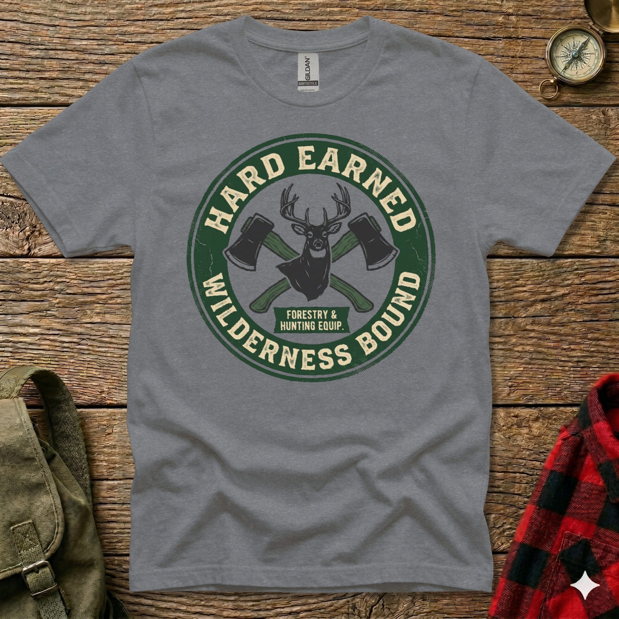 Grey t-shirt with circular "Hard Earned Wilderness Bound" logo featuring crossed axes and antlers.