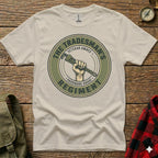 Cream t-shirt with round logo featuring a hand holding a wrench, "Tradesman's Hardware Grade Regiment".