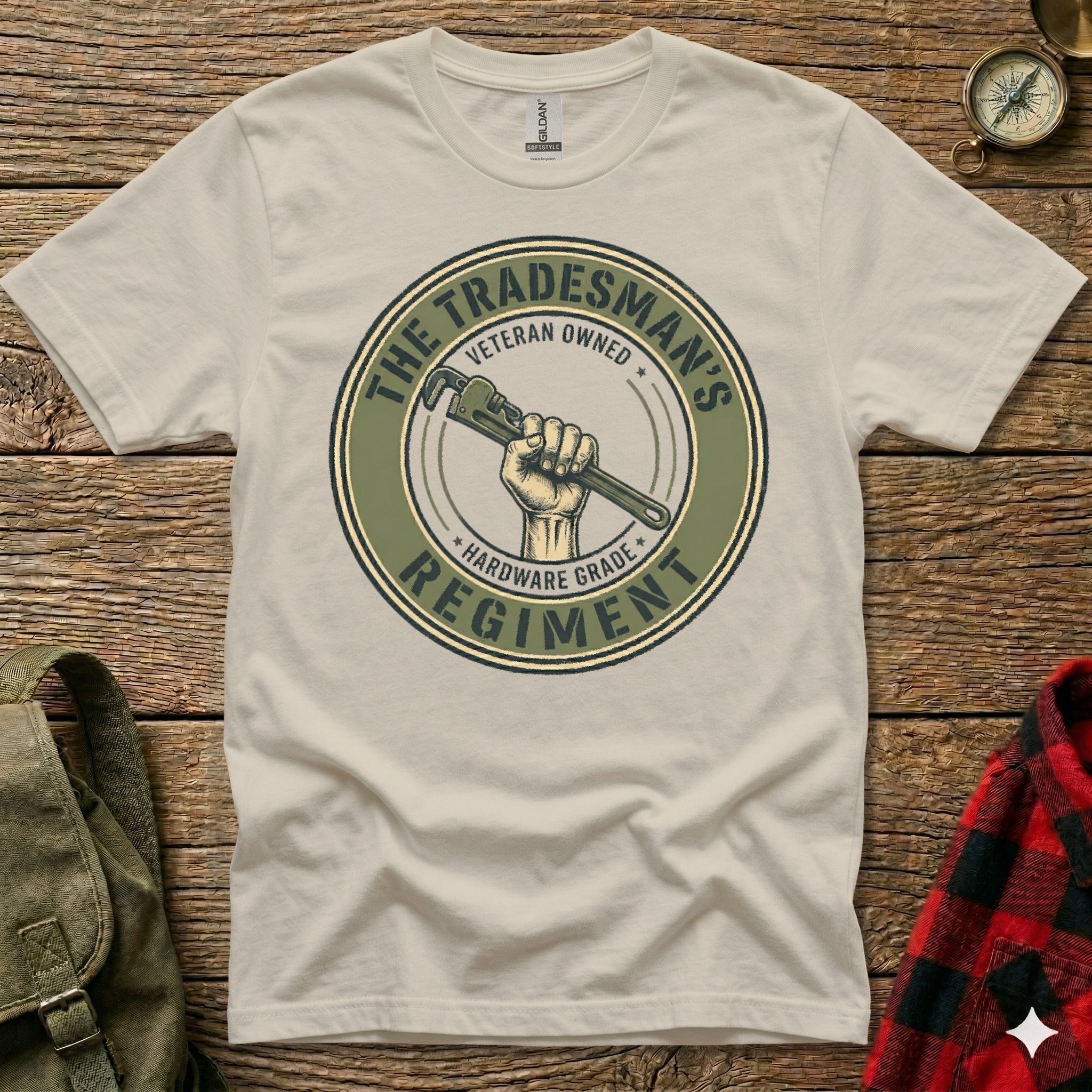 Cream t-shirt with round logo featuring a hand holding a wrench, "Tradesman's Hardware Grade Regiment".