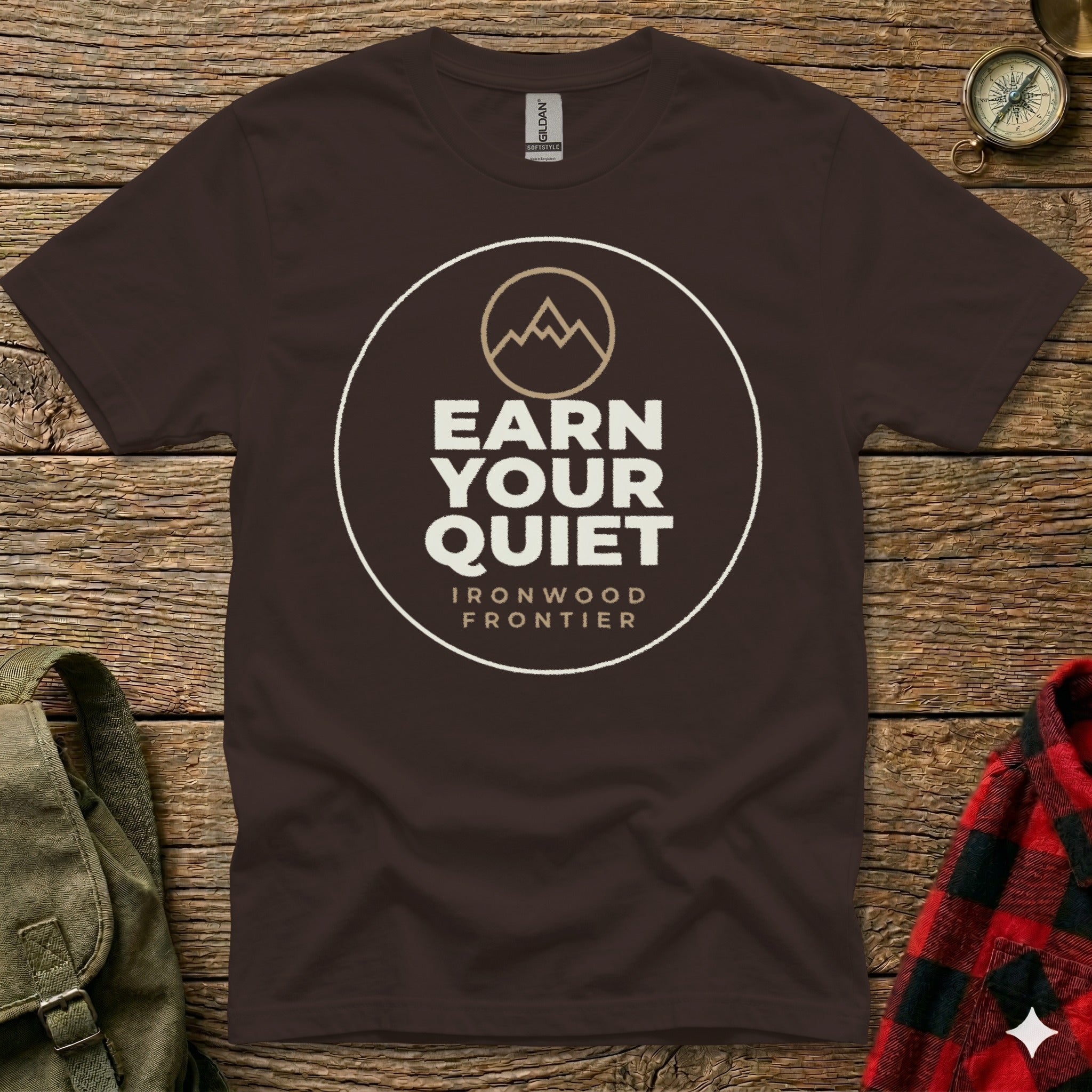 Brown t-shirt with "Earn Your Quiet" and "Ironwood Frontier" text and mountain logo.