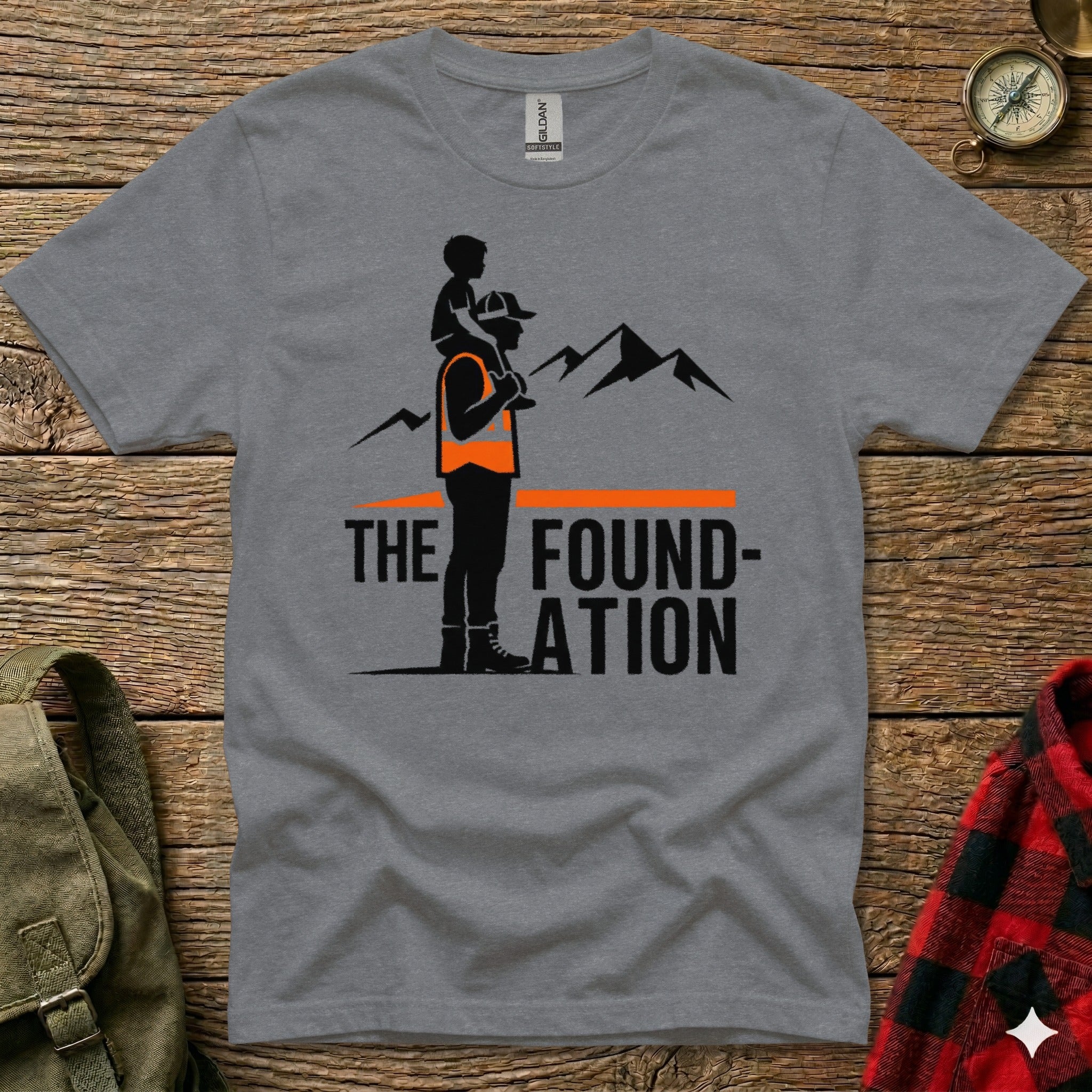 Grey t-shirt with "THE FOUNDATION" graphic of father carrying son and mountains.
