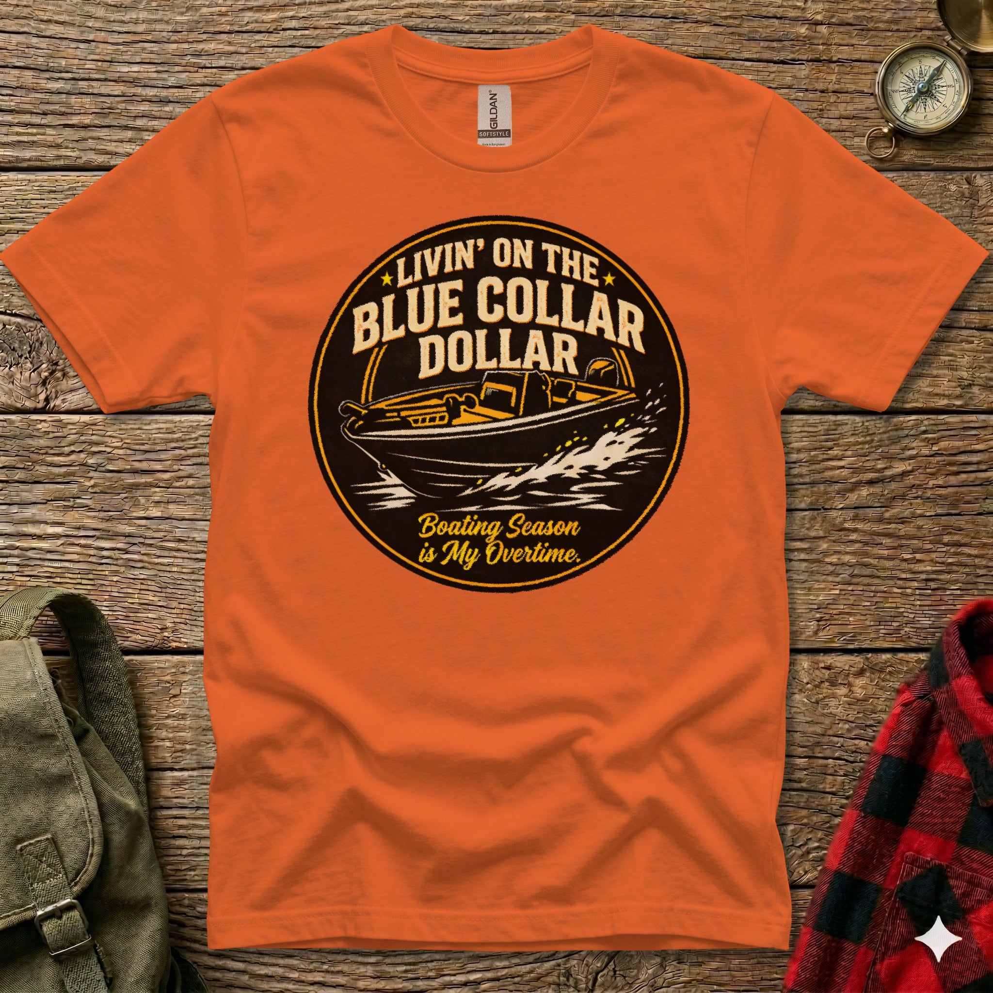 Orange t-shirt graphic with boat and text "Livin' on the Blue Collar Dollar".