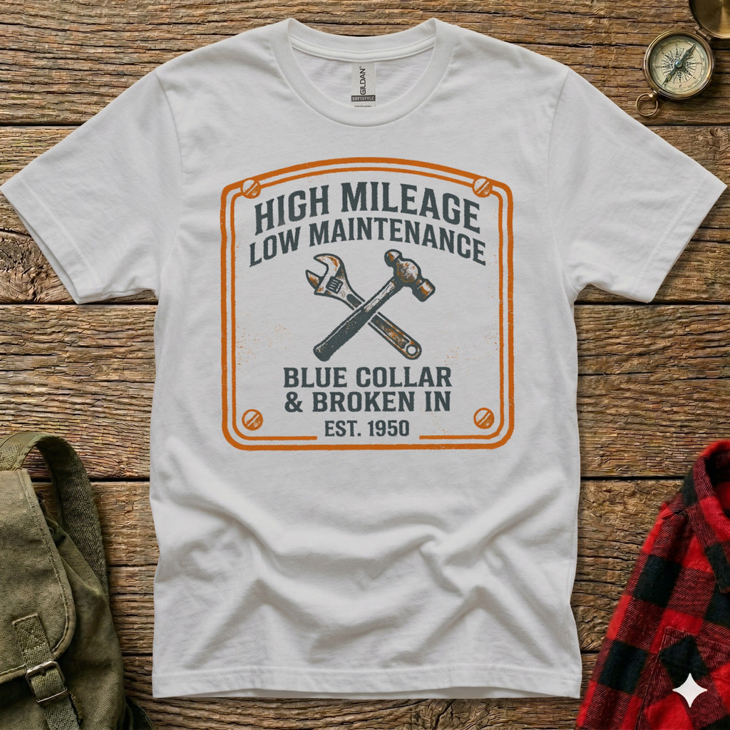 White t-shirt with orange graphic: "High Mileage Low Maintenance Blue Collar & Broken In Est. 1950".