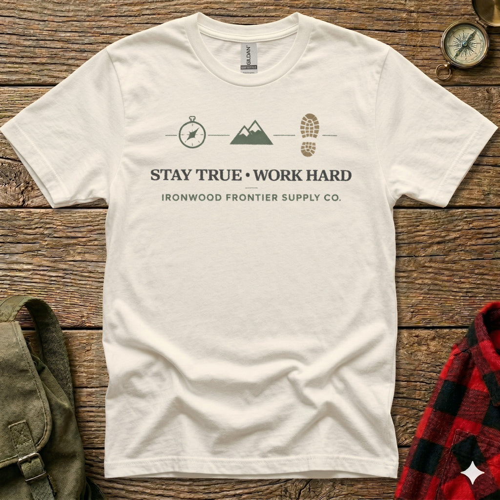 Cream t-shirt with "Stay True, Work Hard" and compass, mountain, boot graphic.