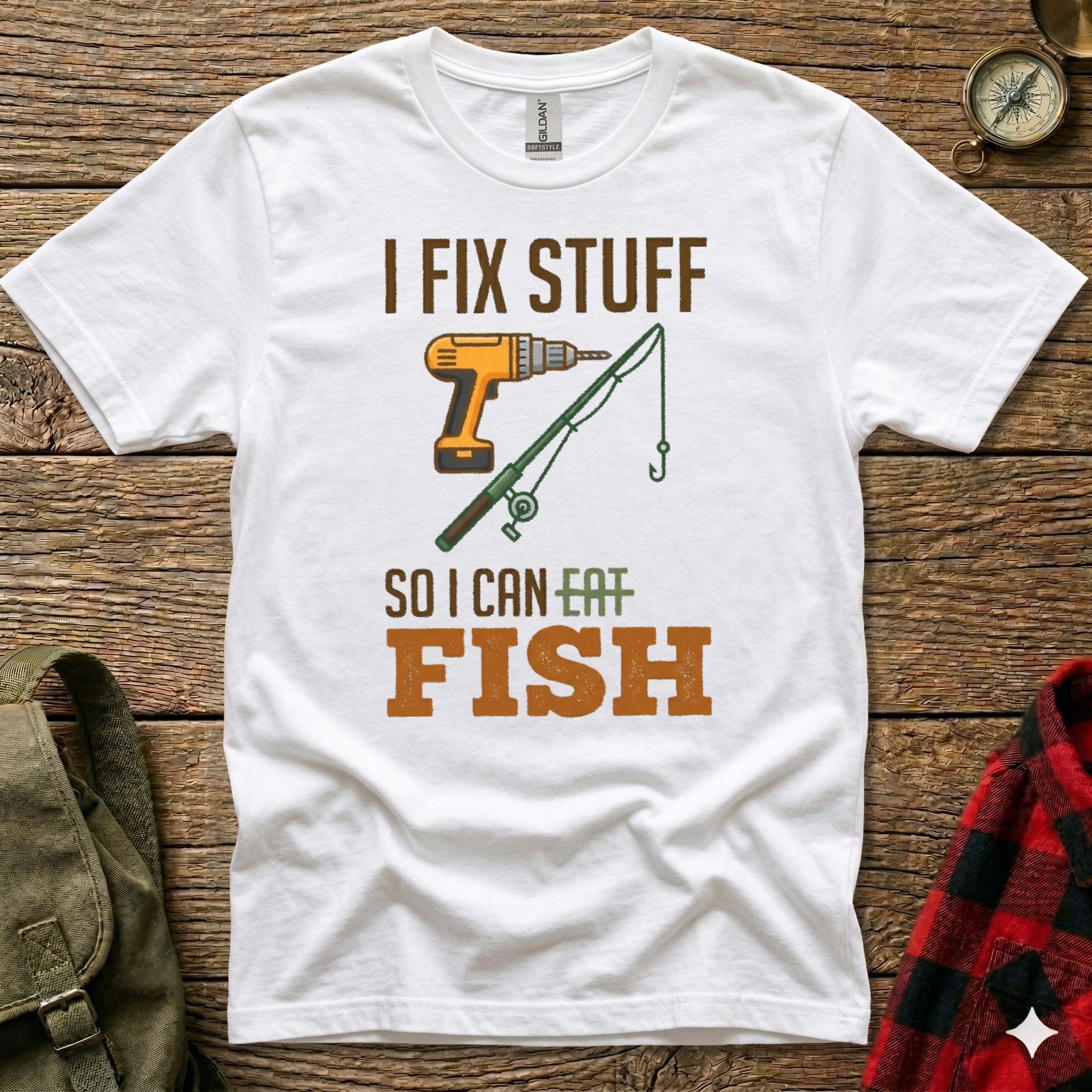 White t-shirt with text "I FIX STUFF SO I CAN EAT FISH" and illustrations.