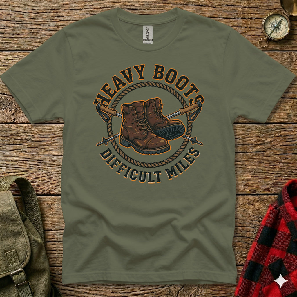 Olive green t-shirt with boots and poles graphic: "Heavy Boots Difficult Miles".
