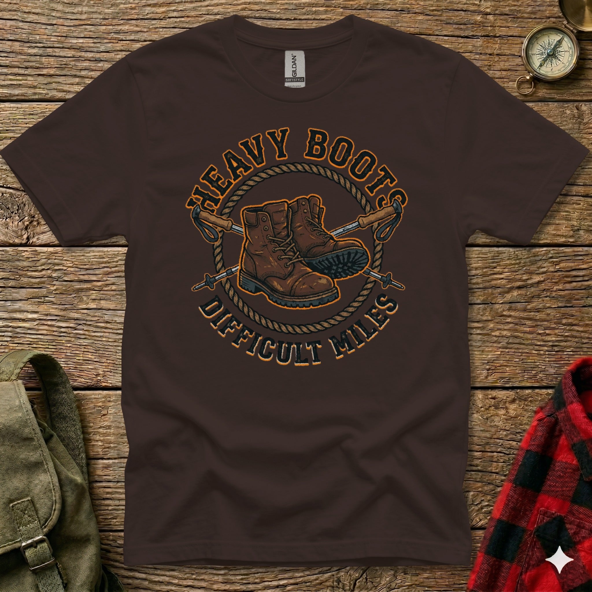 Brown t-shirt with "Heavy Boots Difficult Miles" text and hiking boots graphic.