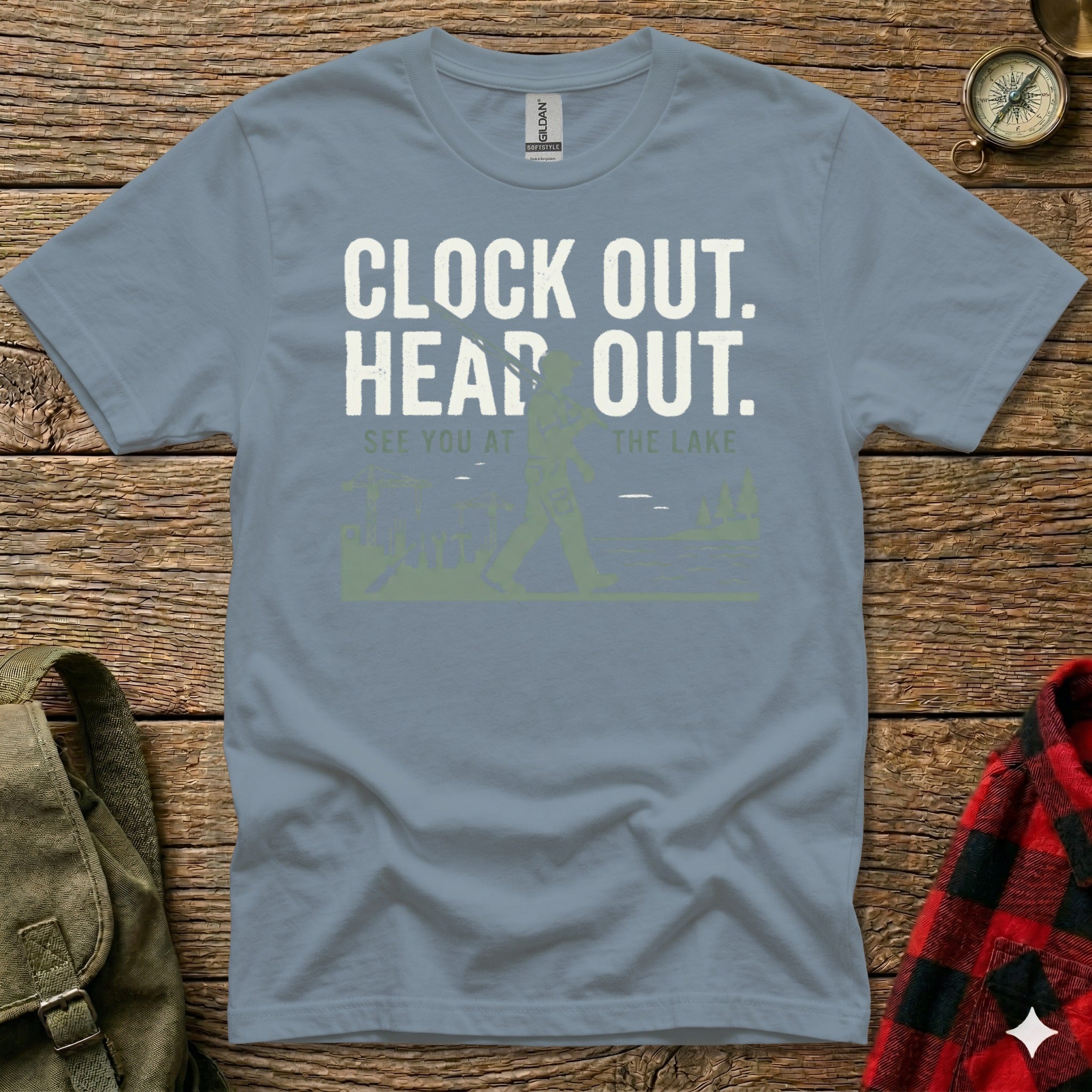 Grey t-shirt with text "CLOCK OUT. HEAD OUT. SEE YOU AT THE LAKE" and Bigfoot graphic.