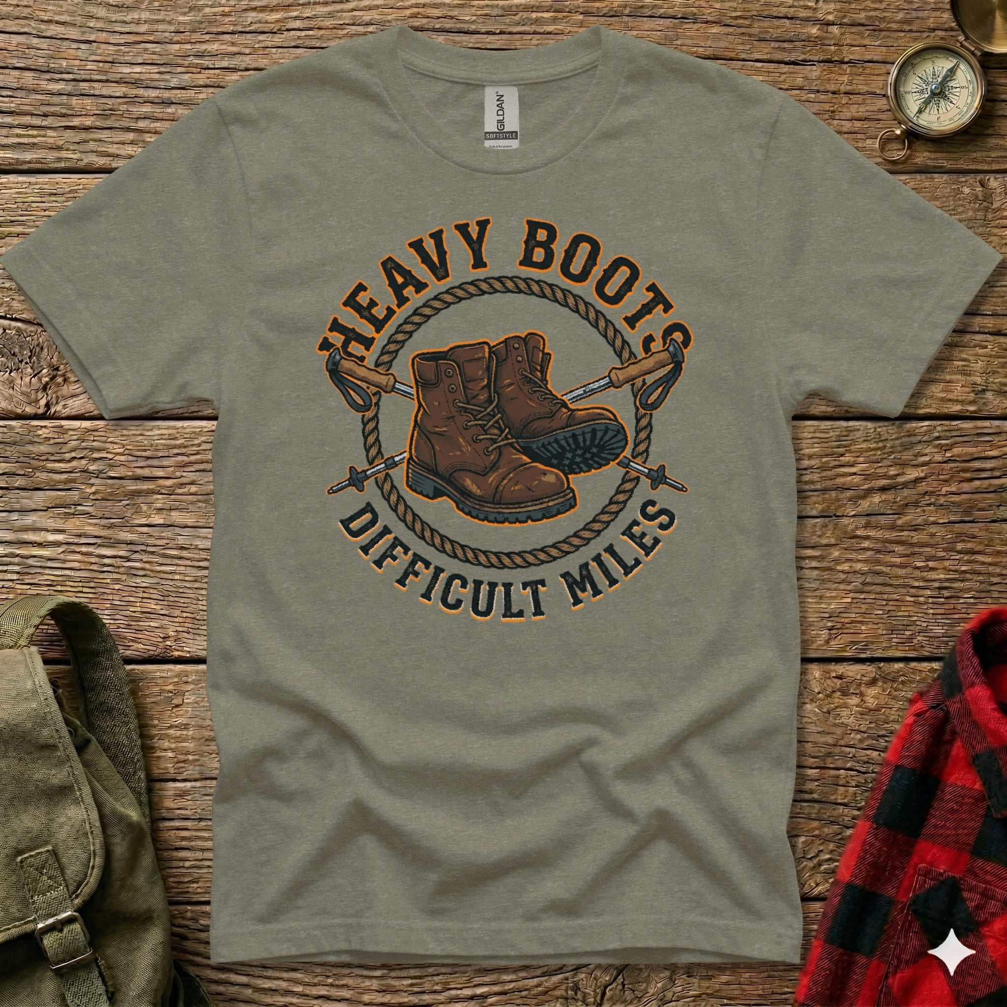 Green t-shirt with "HEAVY BOOTS DIFFICULT MILES" and hiking boots graphic.