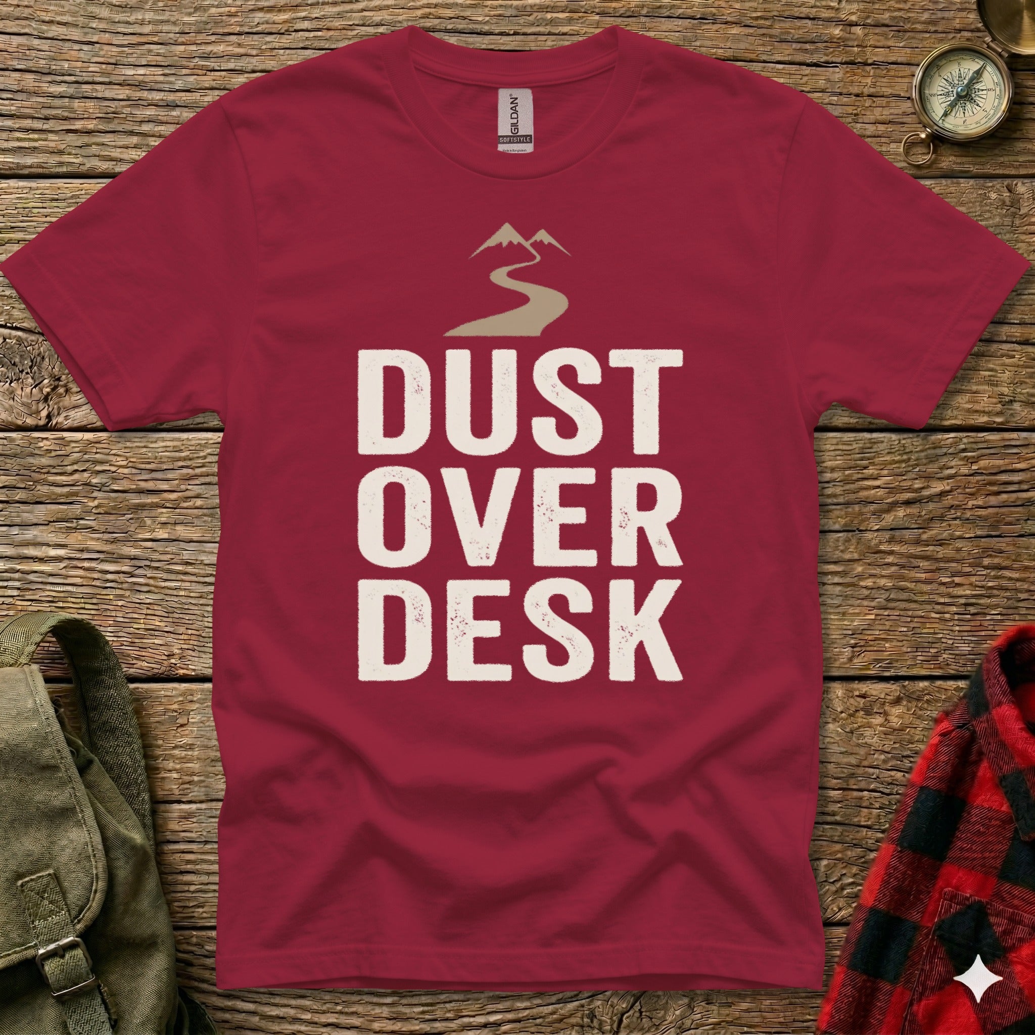 Maroon t-shirt with "Dust Over Desk" text and mountain graphic.