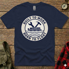 Navy t-shirt with "BUILT TO WORK BORN TO FLOAT" text and wrench and hammer graphic.