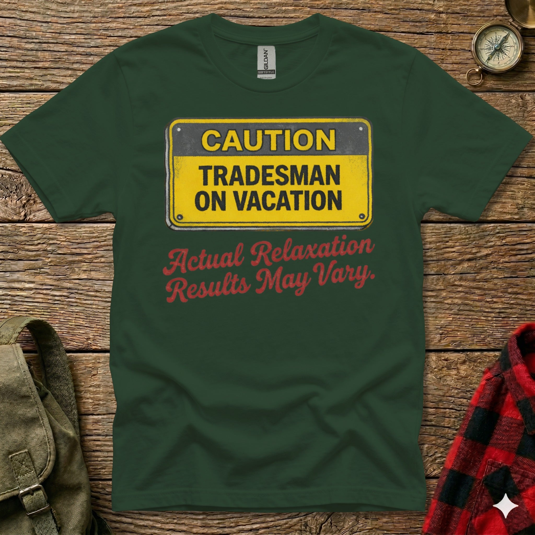 Green t-shirt with "CAUTION TRADESMAN ON VACATION Actual Relaxation Results May Vary." warning sign graphic.