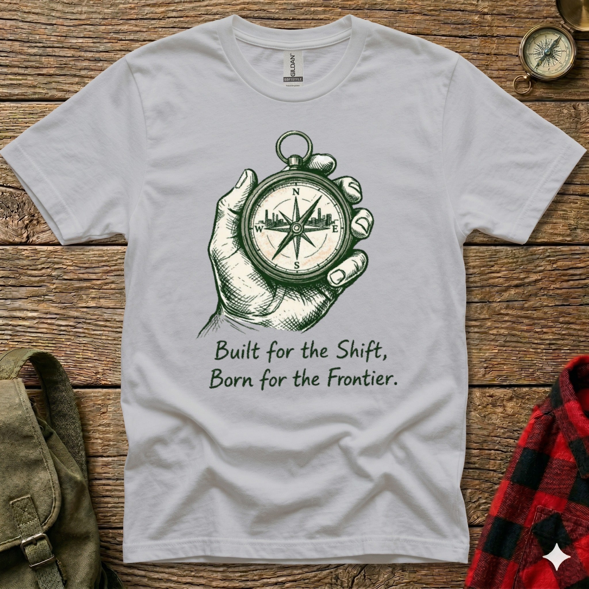 Gray t-shirt with compass graphic and "Built for the Shift, Born for the Frontier." text.