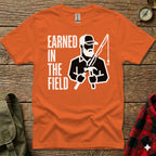 Orange t-shirt with "EARNED IN THE FIELD" and graphic of man fishing and hammering.