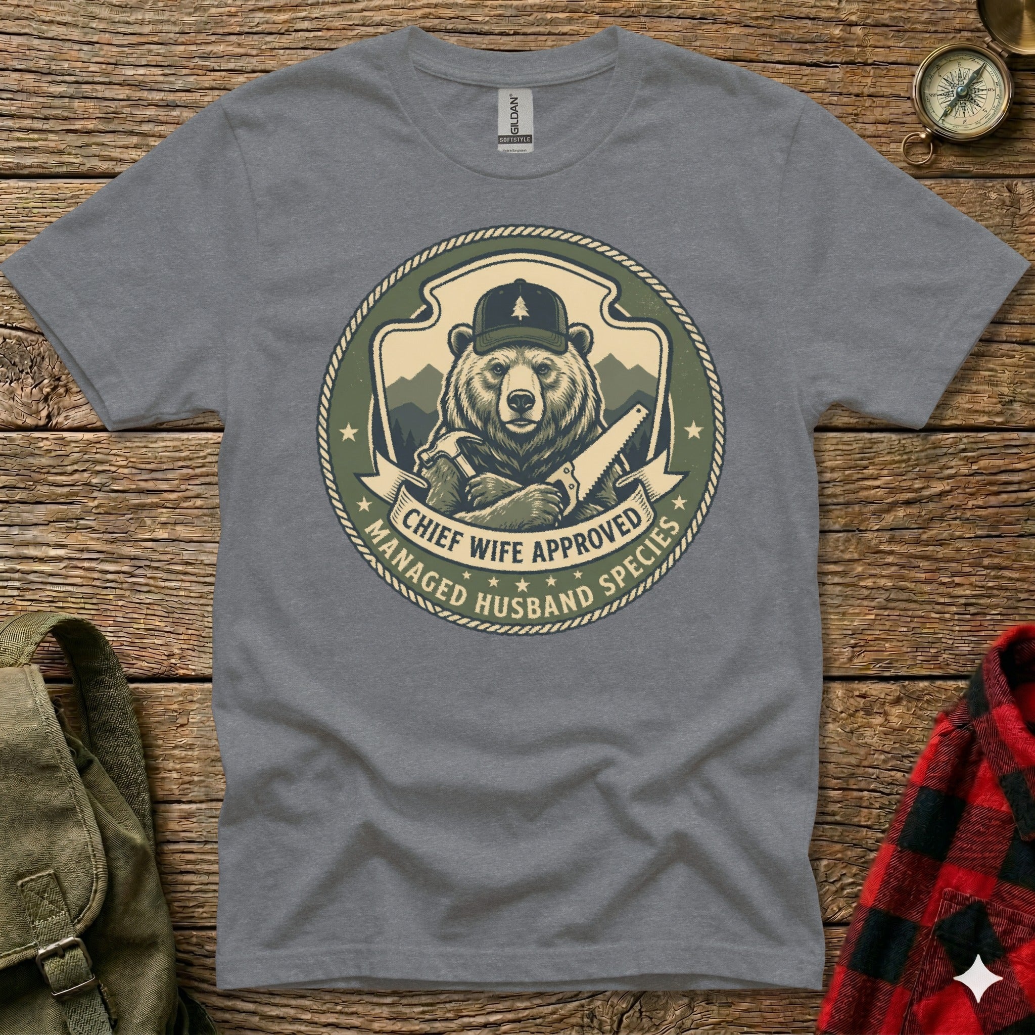 Graphic tee with bear in hat holding saw, "Chief Wife Approved Managed Husband Species" text.