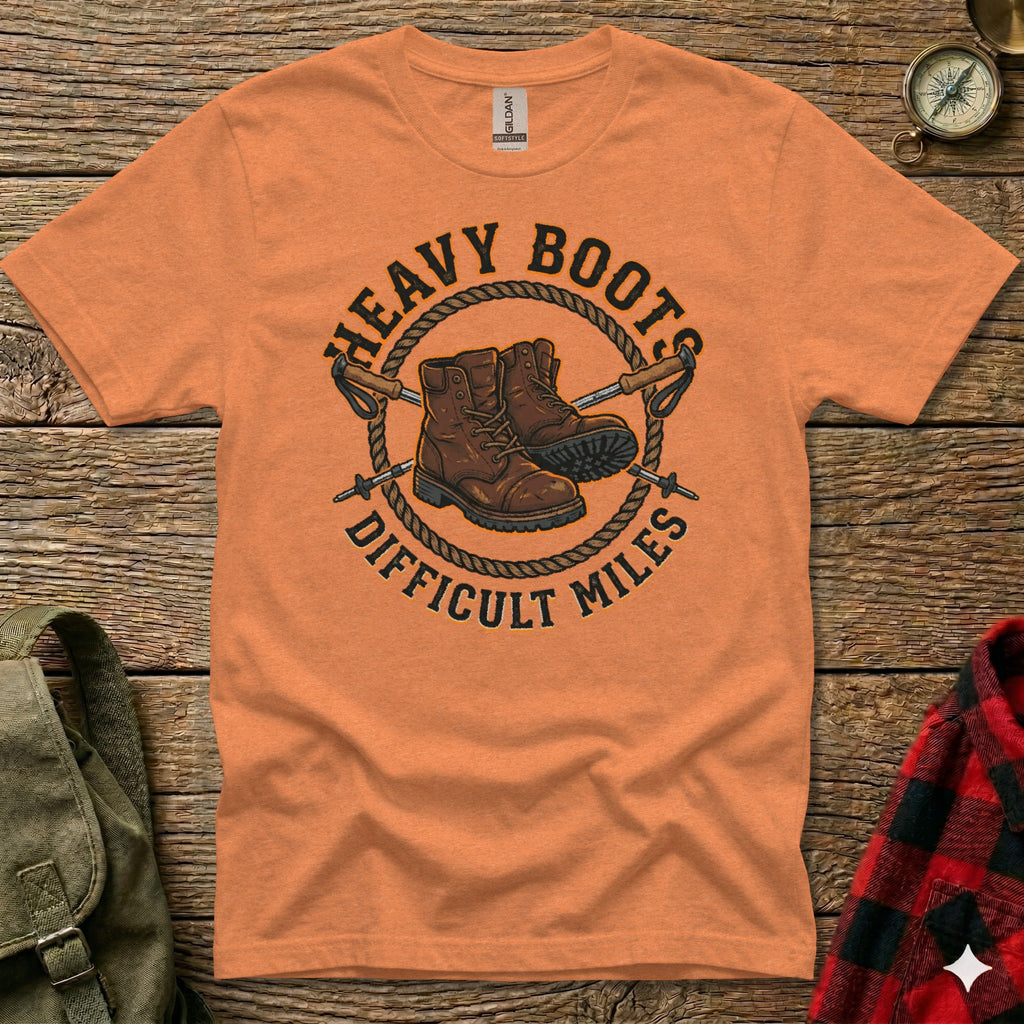 Orange t-shirt with "Heavy Boots Difficult Miles" text and hiking boots graphic.