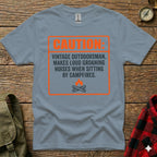 Grey t-shirt with "Caution Vintage Outdoorsman" text and campfire graphic.