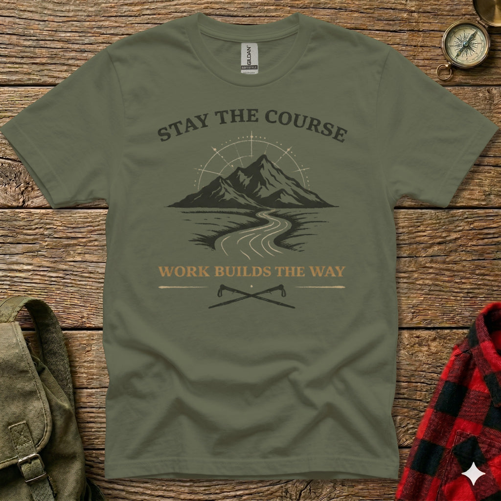 Olive green t-shirt with mountains, road, and crossed axes; text reads "STAY THE COURSE" and "WORK BUILDS THE WAY".