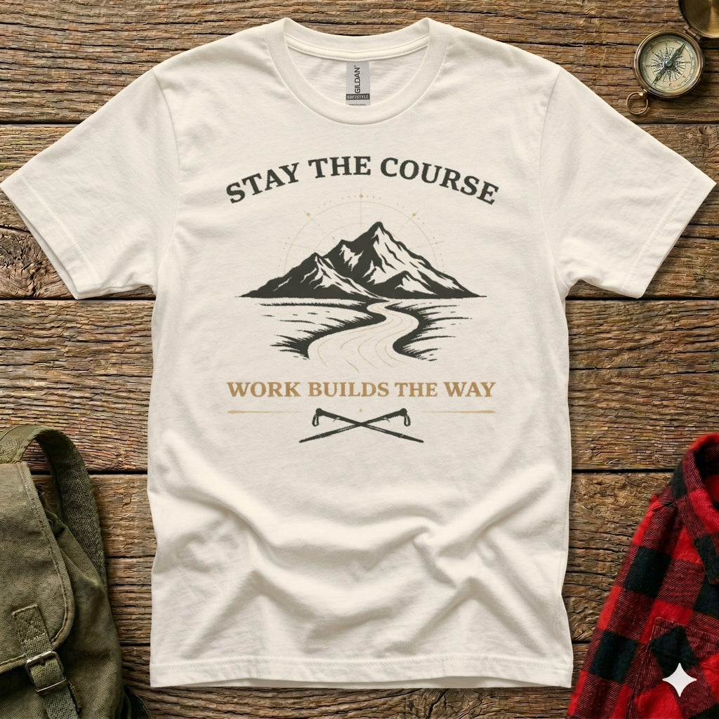 Cream t-shirt with mountain and road graphic, "Stay the Course" and "Work Builds the Way."
