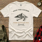 Cream t-shirt with mountain and road graphic, "Stay the Course" and "Work Builds the Way."