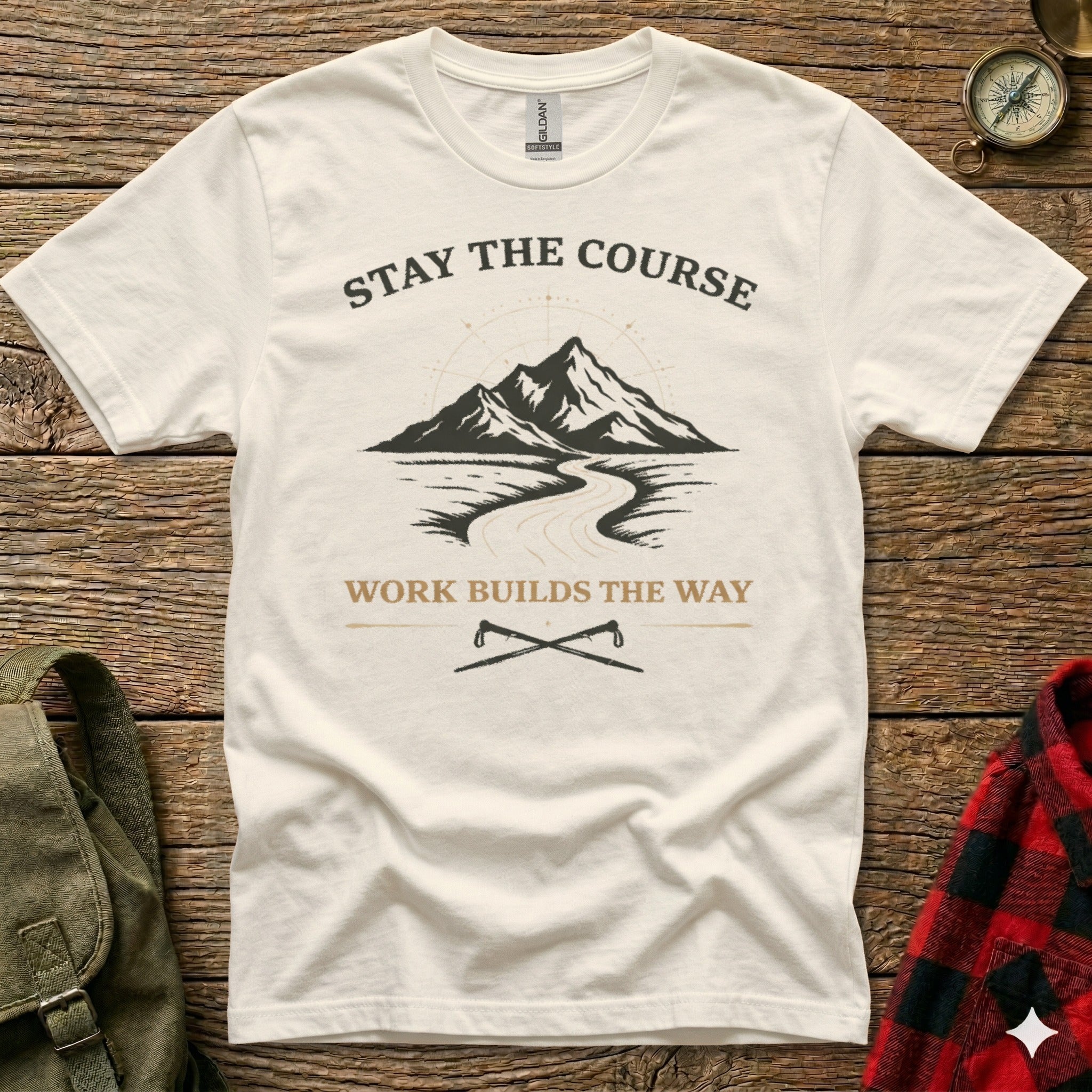 Cream t-shirt with mountain and road graphic, "Stay the Course" and "Work Builds the Way."