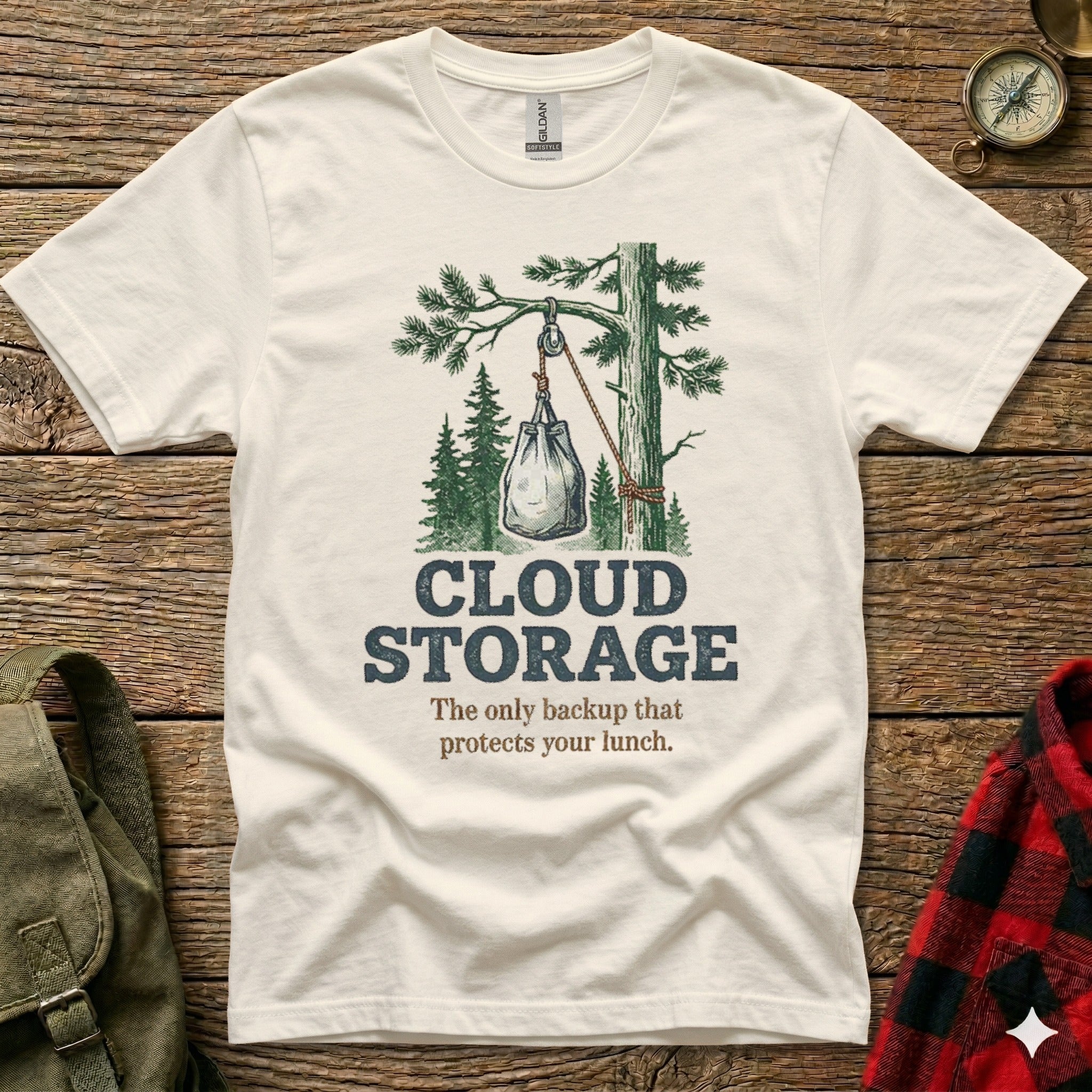 White t-shirt with graphic of lunch bag hanging from tree branch labeled "Cloud Storage".