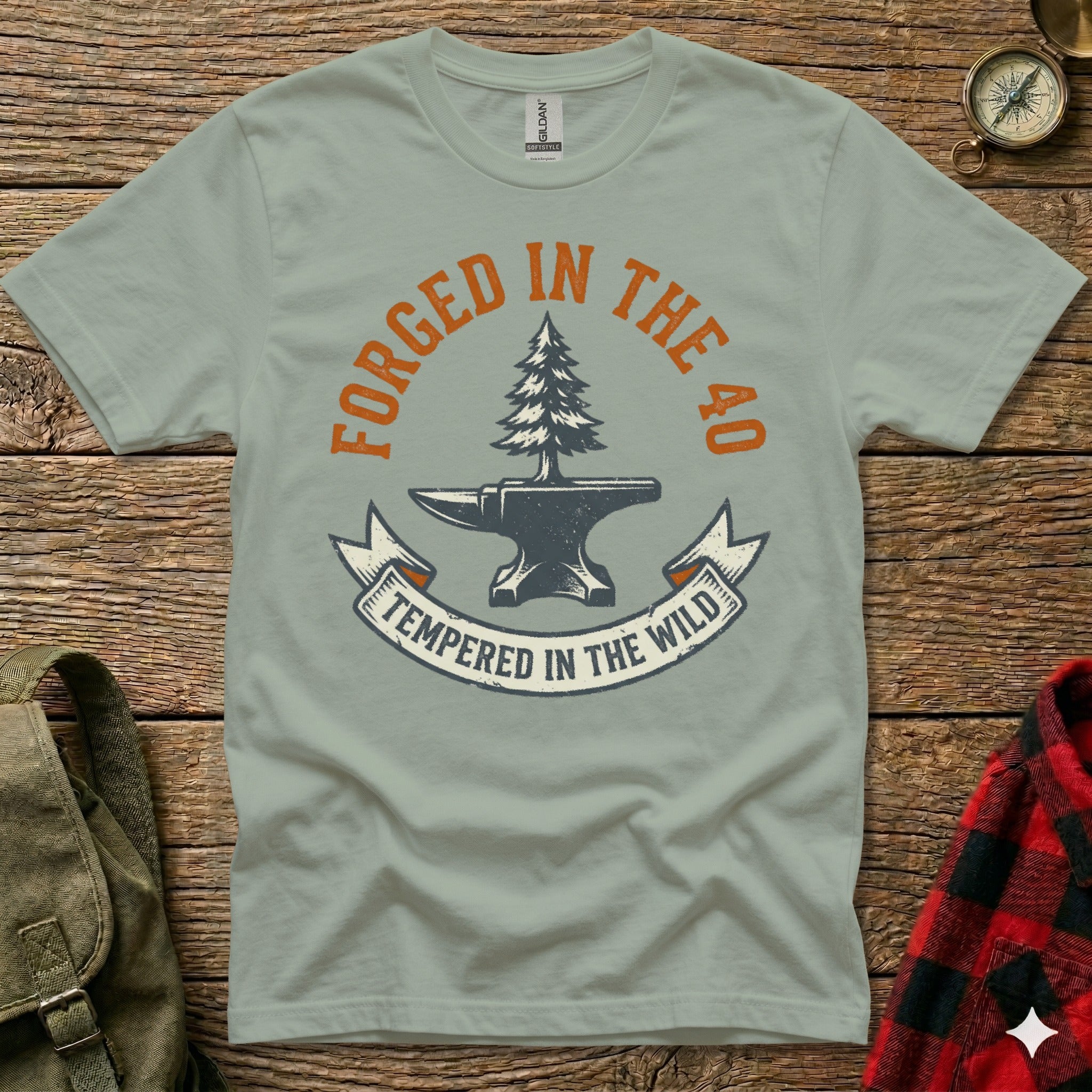 Green t-shirt with "Forged in the 40, Tempered in the Wild" and an anvil.