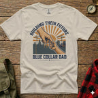 T-shirt graphic: Hand holding child's hand, construction scene, "Building Their Future Blue Collar Dad".