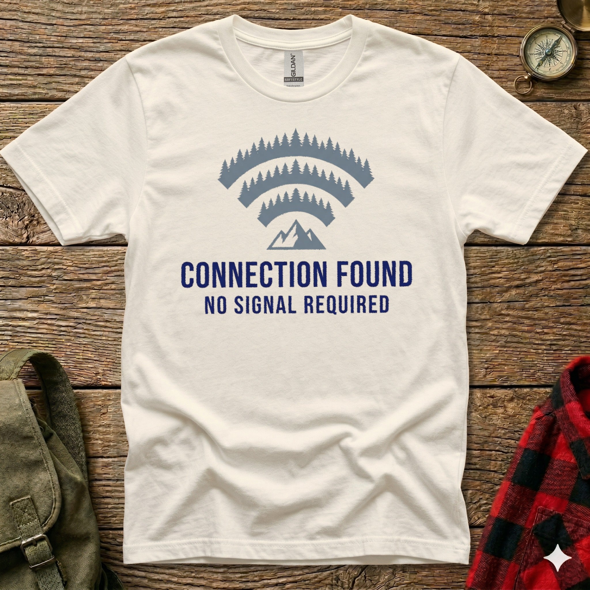 White t-shirt with "CONNECTION FOUND NO SIGNAL REQUIRED" and a mountain and trees signal icon.