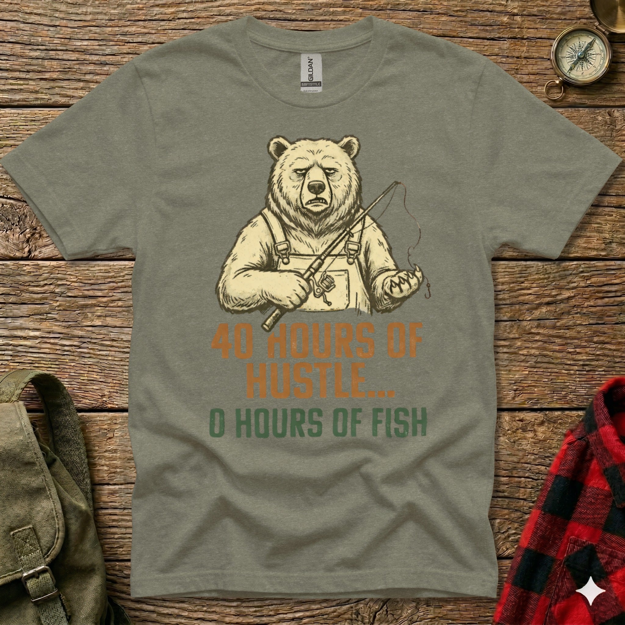 T-shirt graphic of a bear holding a fishing rod with text "40 HOURS OF HUSTLE, 0 HOURS OF FISH".