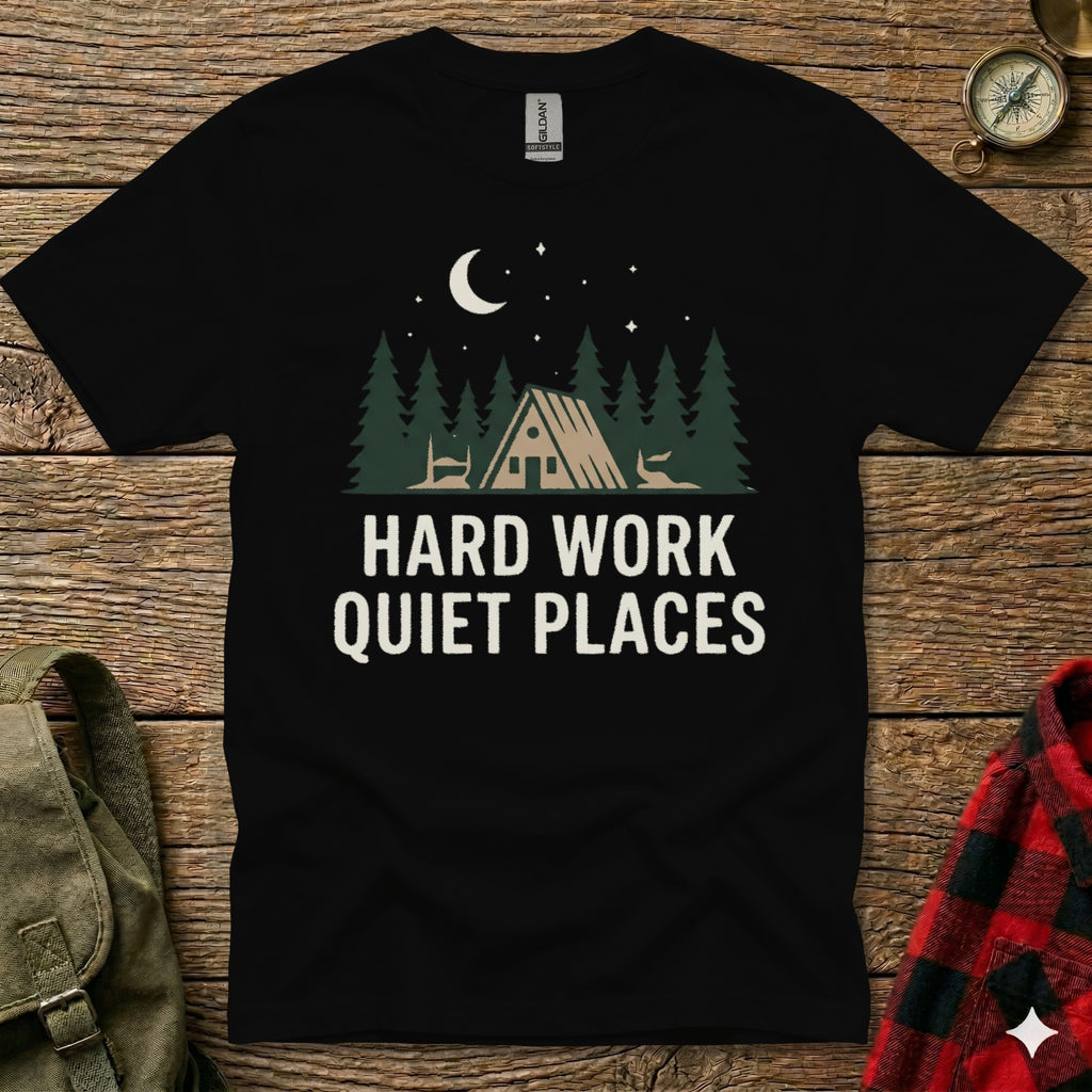 Black t-shirt with "HARD WORK QUIET PLACES" and forest cabin graphic.