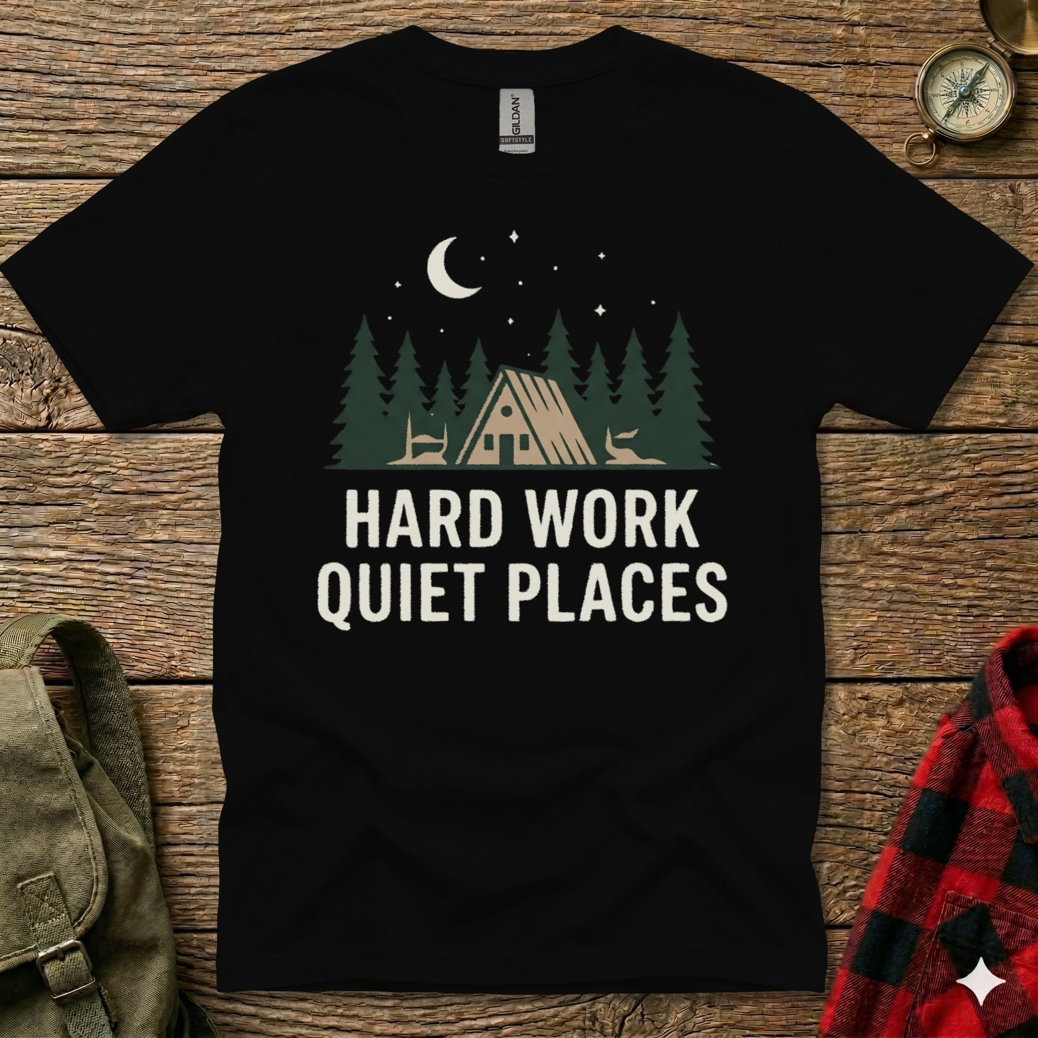 Black t-shirt with "HARD WORK QUIET PLACES" and forest cabin graphic.