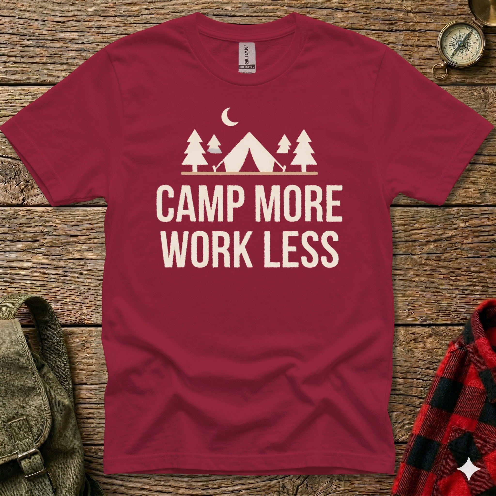 Maroon t-shirt with "CAMP MORE WORK LESS" text and camping graphic.