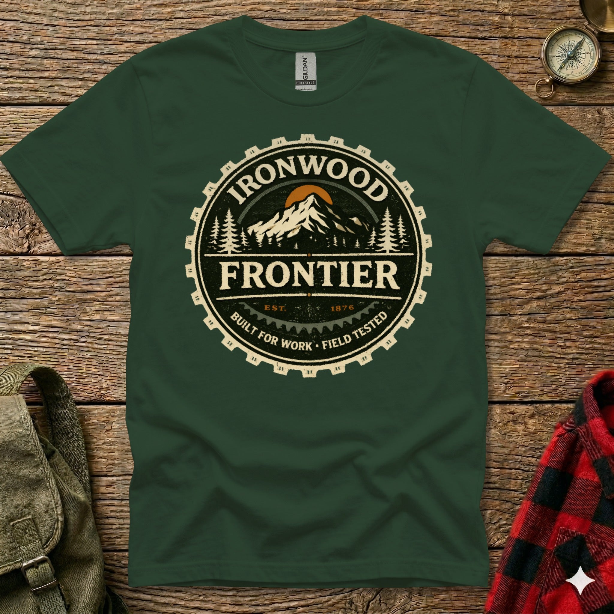 Green t-shirt with round Ironwood Frontier logo featuring mountains and text.