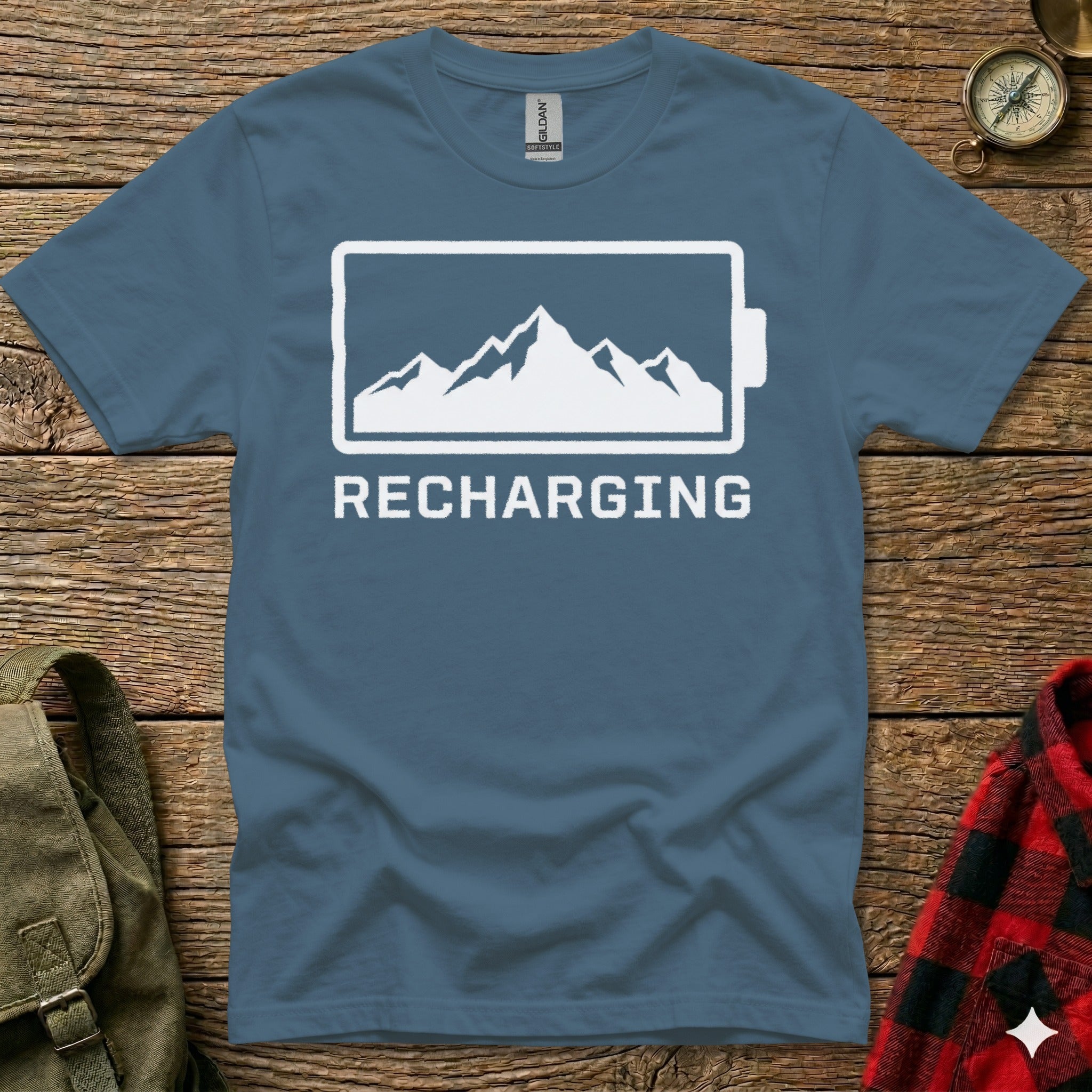 Blue t-shirt with mountain graphic and "Recharging" text.
