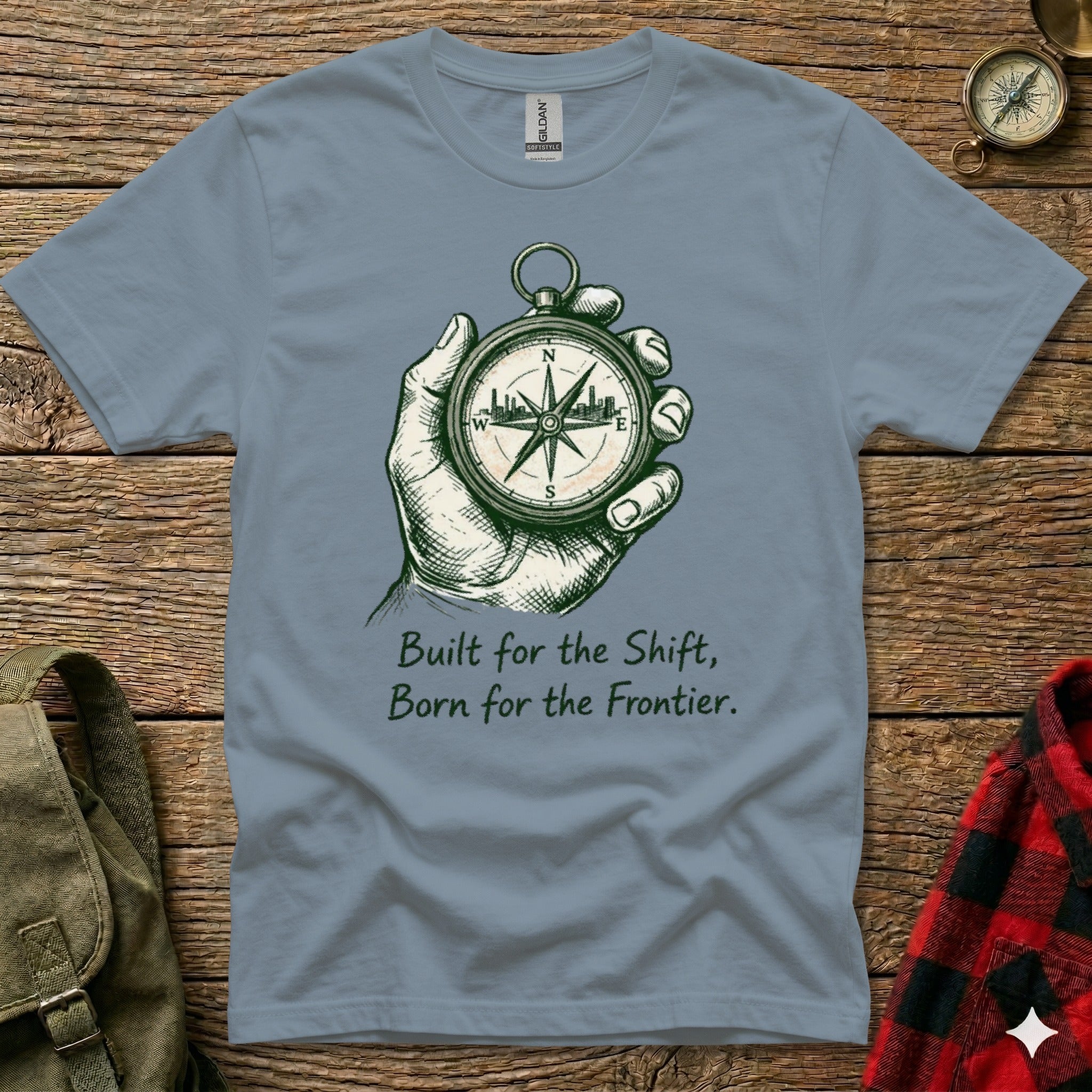 Grey t-shirt with compass graphic and text "Built for the Shift, Born for the Frontier."