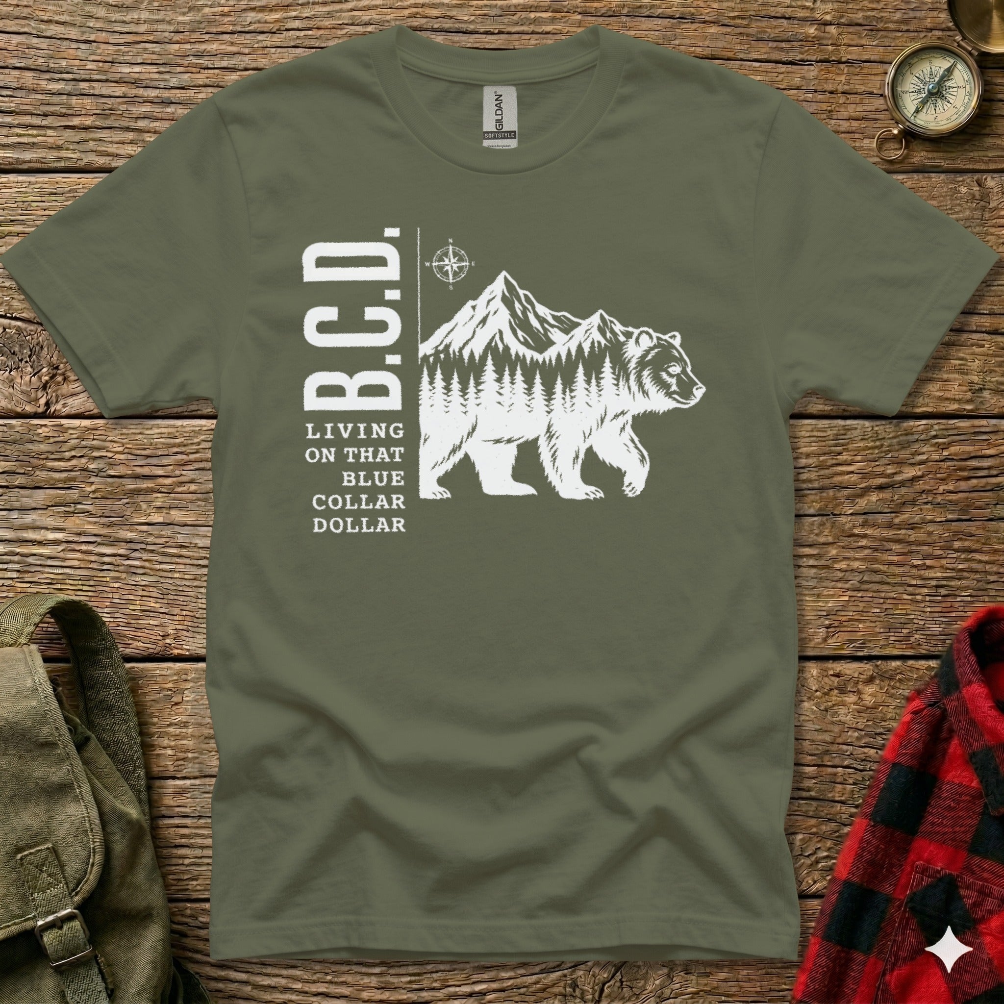 T-shirt with white graphic of a bear, mountains, and text "B.C.D. Living on that blue collar dollar."