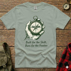 T-shirt with hand holding a compass and text "Built for the Shift, Born for the Frontier."