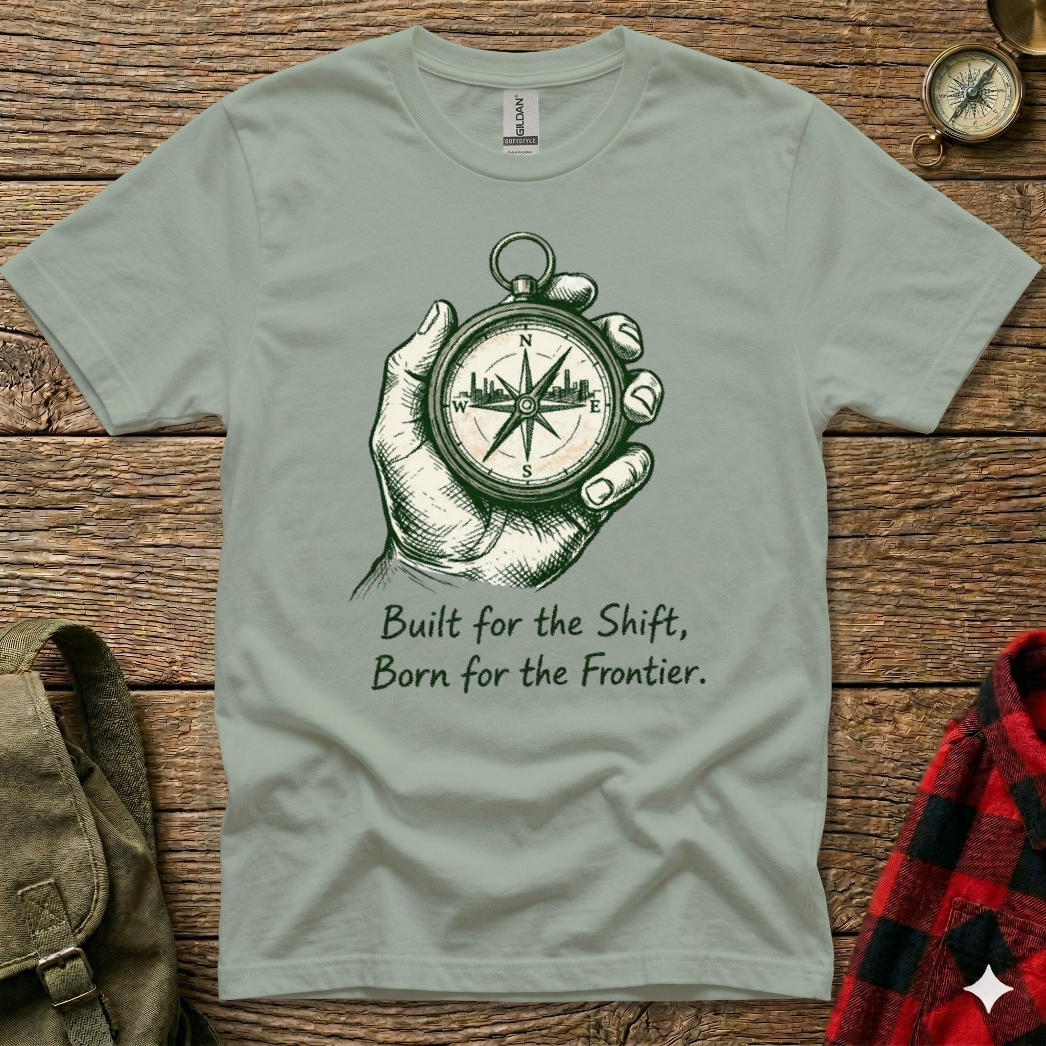 T-shirt with hand holding a compass and text "Built for the Shift, Born for the Frontier."