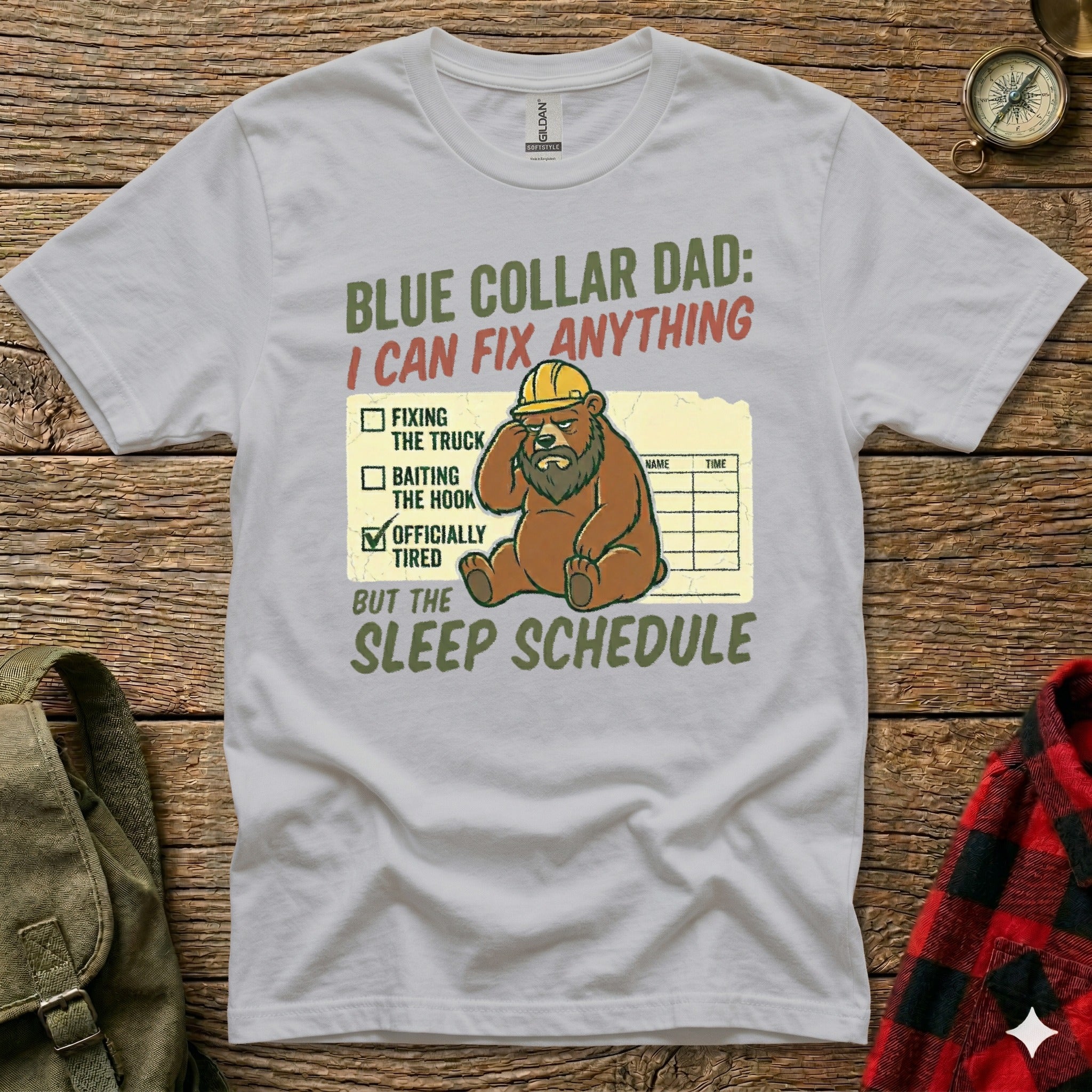 T-shirt with a bear wearing a hard hat, humorously listing tasks as "Fixing the truck," "Baiting the hook," and "Officially tired" under "Sleep Schedule."