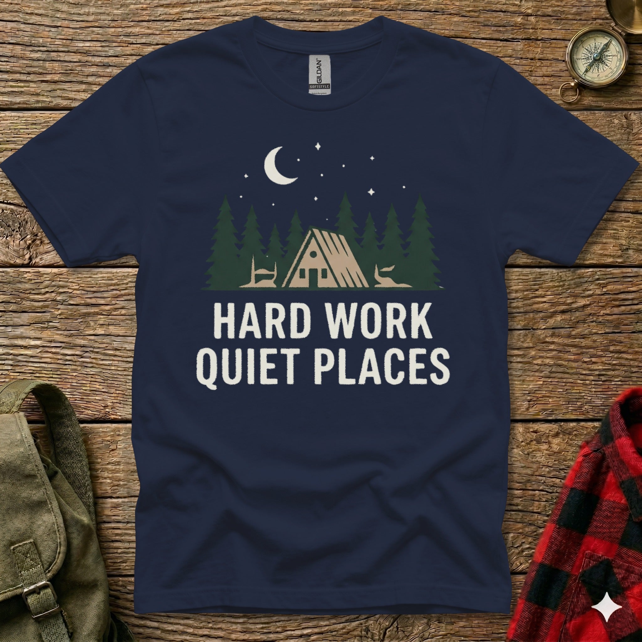 Navy t-shirt with "Hard Work Quiet Places" and a cabin in the woods graphic.