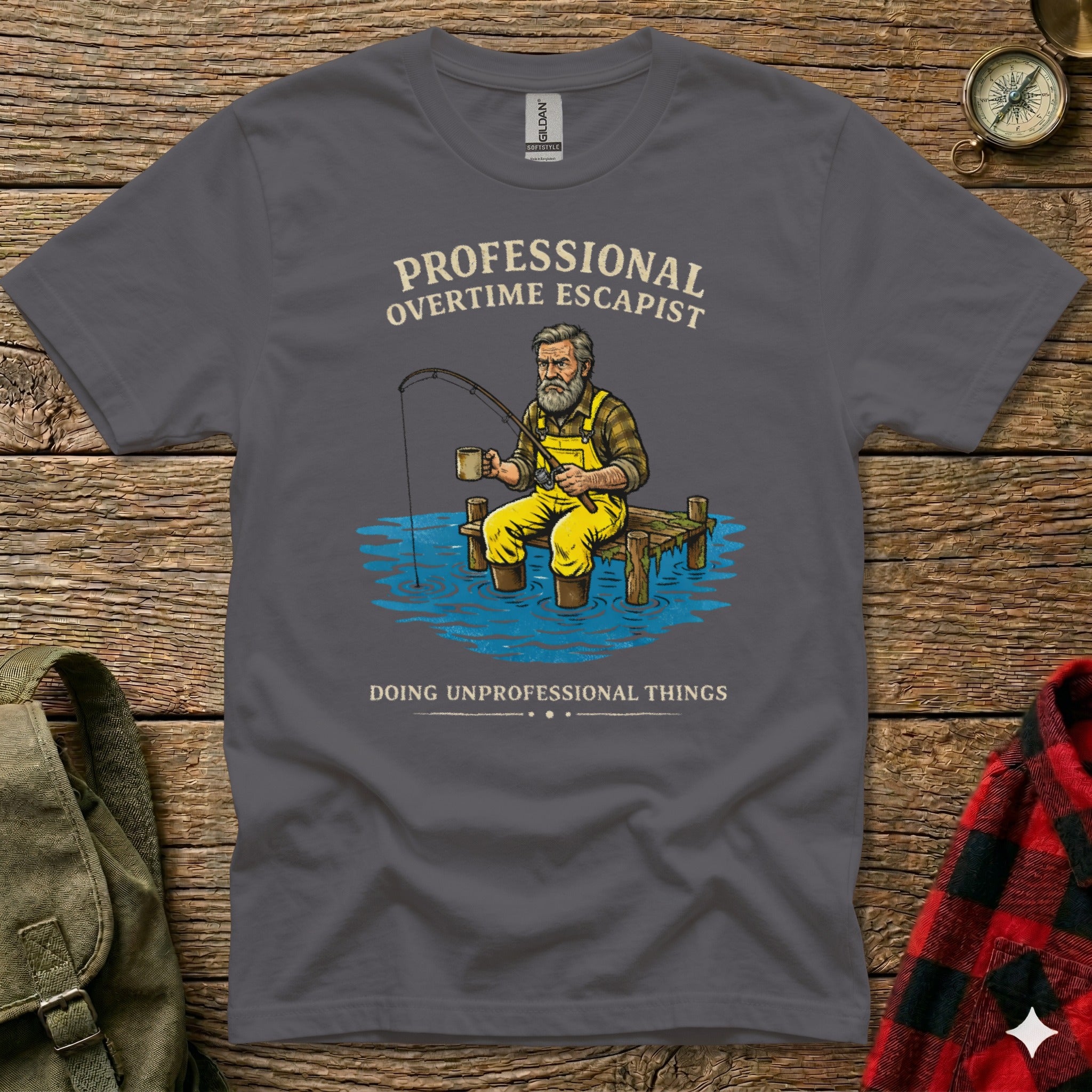T-shirt with graphic: man fishing, "PROFESSIONAL OVERTIME ESCAPIST", "DOING UNPROFESSIONAL THINGS".