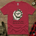 Red t-shirt with compass and text "Built for the Shift, Born for the Frontier."