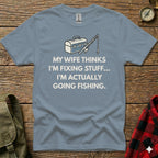 Blue t-shirt with "My wife thinks I'm fixing stuff... I'm actually going fishing" text and fishing graphic.