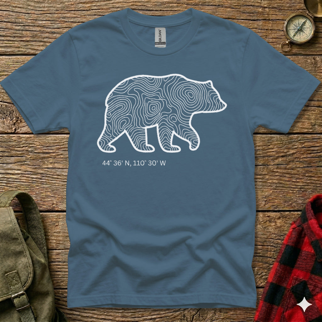 Blue t-shirt with white bear outline filled with topographic lines and coordinates.