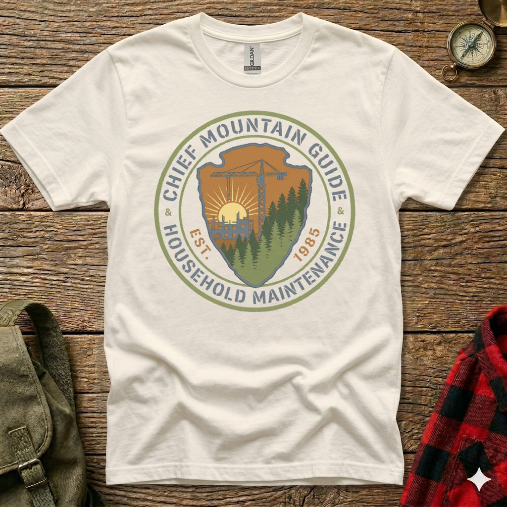 Cream t-shirt with circular logo for "Chief Mountain Guide Household Maintenance est. 1985".