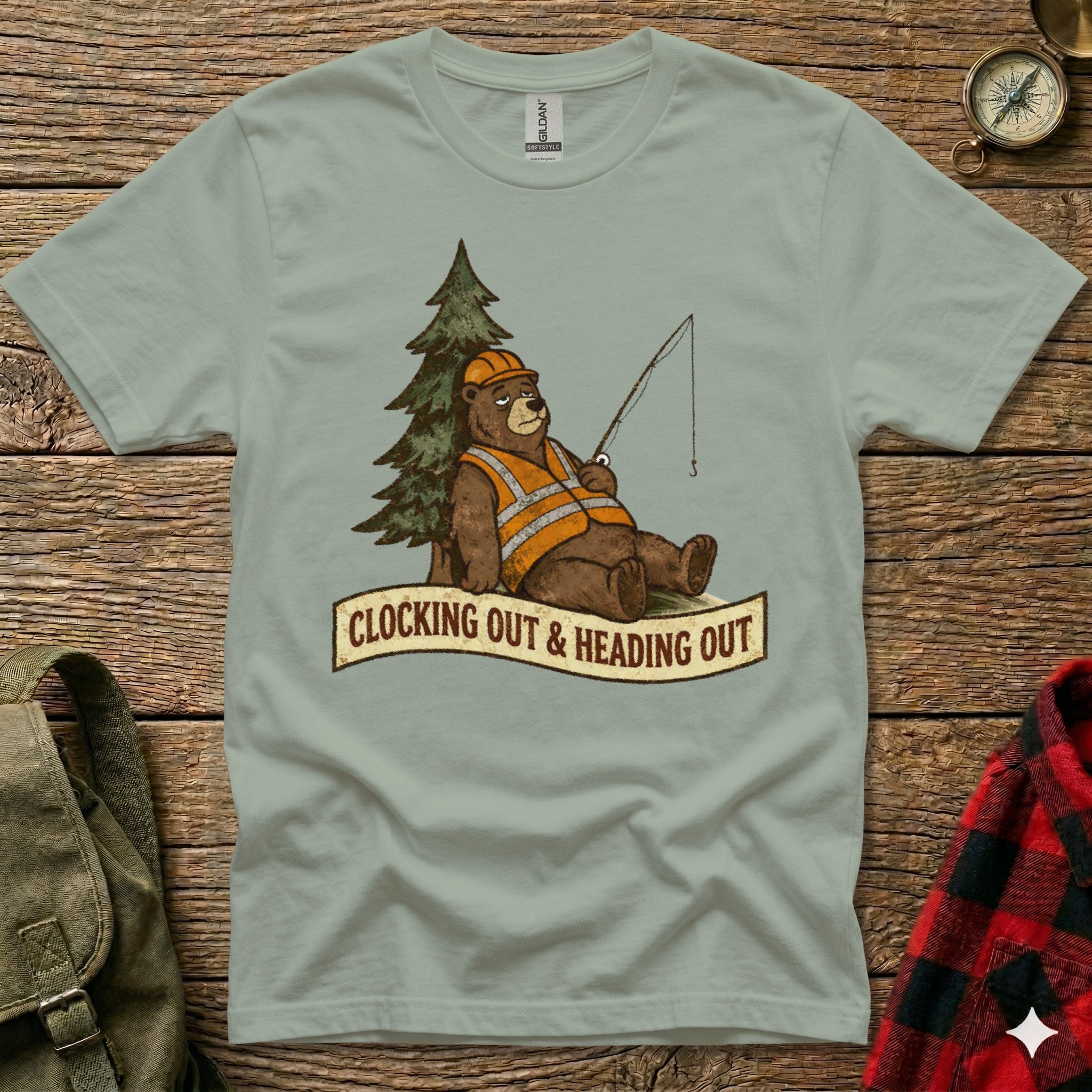 T-shirt featuring a cartoon bear in a hard hat and vest fishing next to a tree.